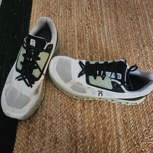 On Running Cream and Black Athletic Shoes